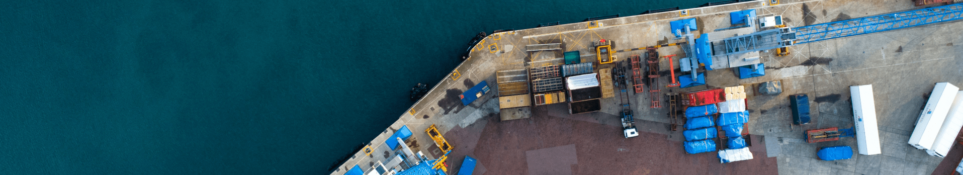 Close-up of commercial vessels and heavy shipping traffic operating within the Piraeus, Greece port.